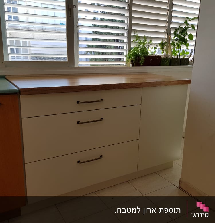 ארונות מטבח עם ידיות מתכת ומשטח עץ